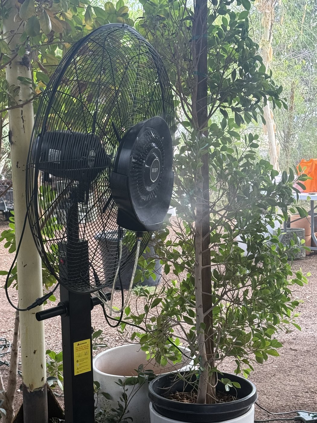 Misting fan in landscaped garden